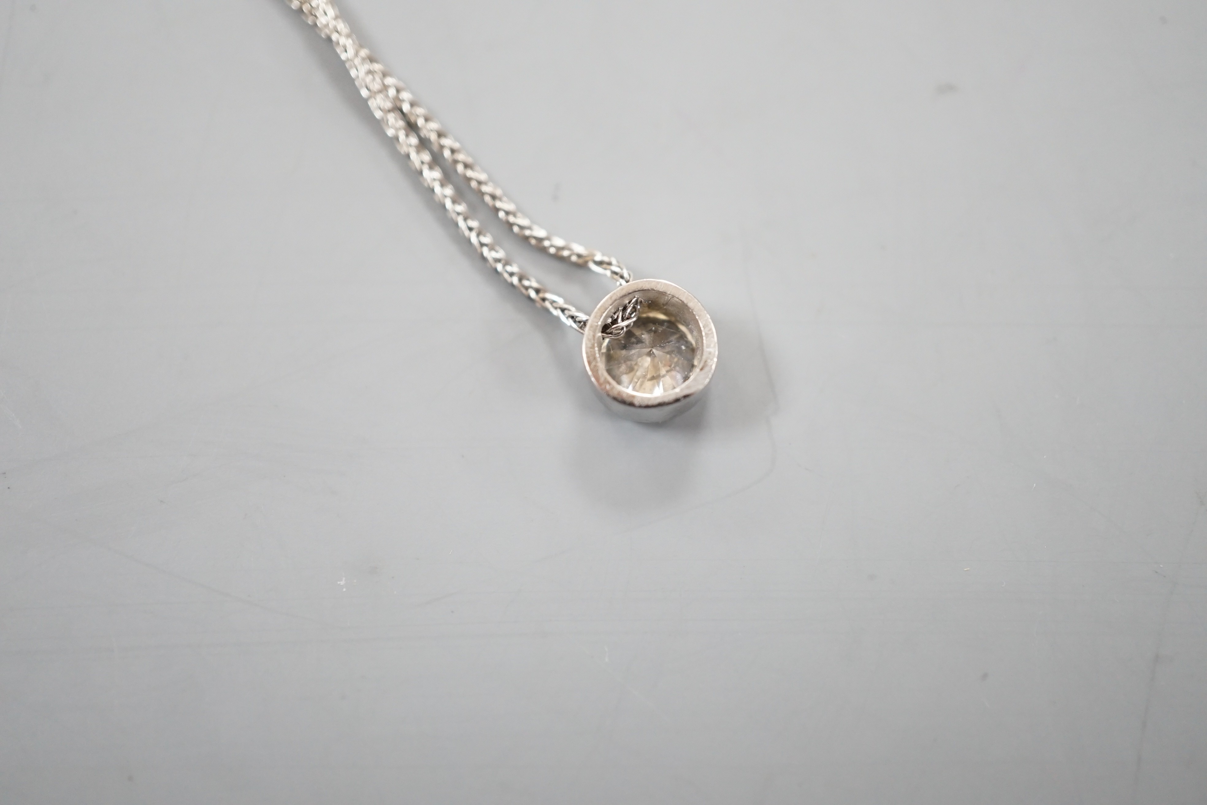 A modern Italian 18ct white gold and collet set solitaire diamond pendant necklace, 38cm, gross weight 3.8 grams